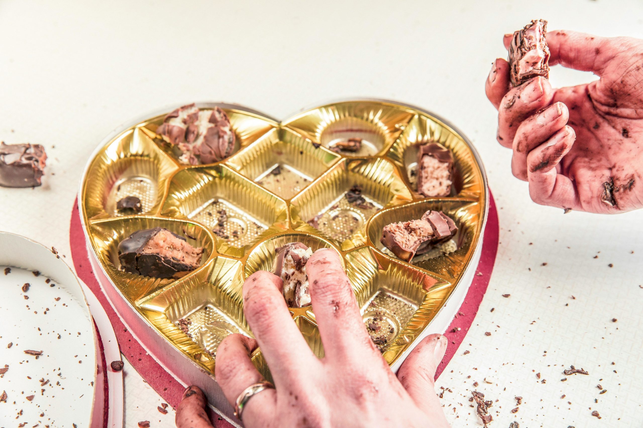 A person eating candy from a box